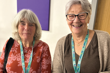 Photo of two Healthwatch Cornwall volunteers smiling to camera